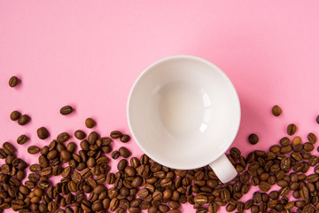 Coffee beans on a pink backround copy space