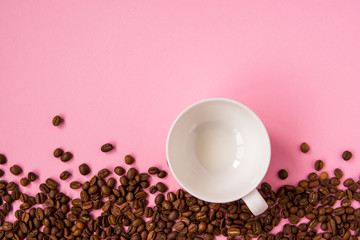 Coffee beans on a pink backround copy space