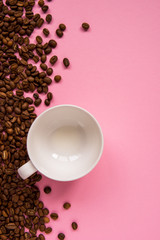Obraz na płótnie Canvas Coffee beans on a pink backround copy space
