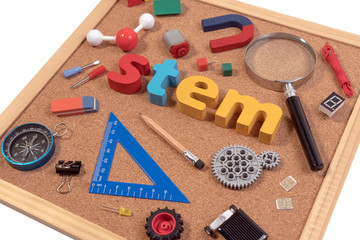 STEM Education. Science Technology Engineering Mathematics. STEM word on cork board with education equipments for background.