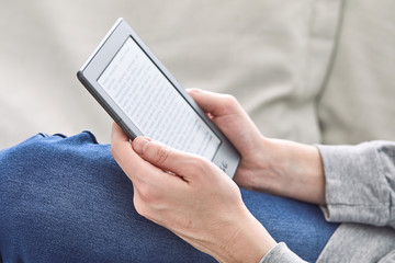 Man reading an e-book on digital tablet device
