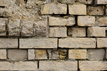 Fragment of a broken brick wall