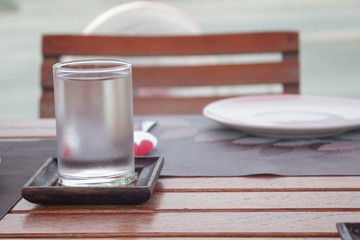Glass, spoon and dish on table