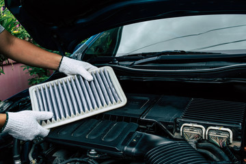 Technician change a new car air filter, Put new air filter on car engine. maintenance car by yoursalf.