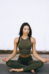 Fototapeta premium Attractive model in yoga pose on white background in sexual clothes