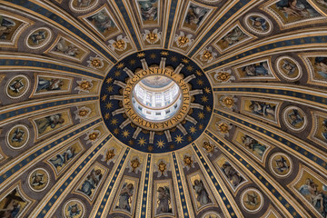 Close-up details of the dome of St. Peter's Basilica, with blue and gold motifs, saints and angels in Vatican, Rome, Italy.