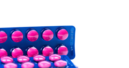 Ibuprofen in pink tablet pills pack in blue blister pack isolated on white background with copy space. Ibuprofen for relief pain, headache, high fever and anti-inflammatory. Painkiller tablets pills.