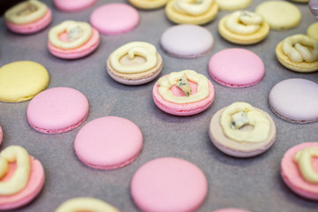 cooking, confectionery and baking concept - macarons on table