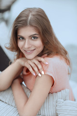 Naklejka premium portrait of young smiling woman in the background of the living room.