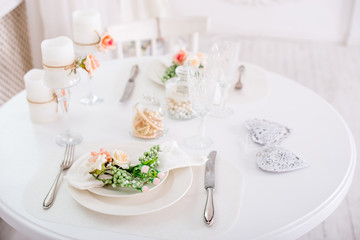 Banquet decorated table, with cutlery. Wedding decor in the banquet hall.Serving of a festive table, plate, napkin, knife, fork. Table setting decoration. Romantic Dinner or other events