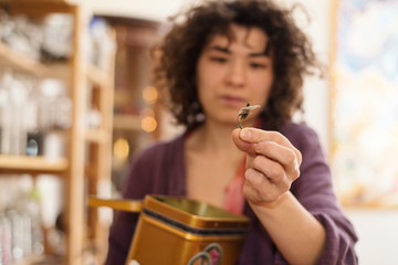 
Woman asian seller in a tea shop holding a sheet of tea
