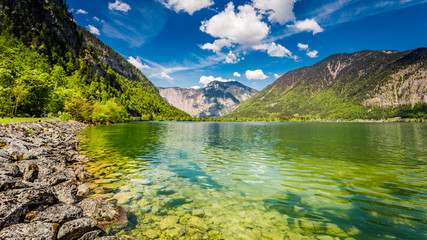 Fototapeta na wymiar Green mountain lake and Alps in spring