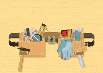 Tools in tool belt with side release buckle strap on wood background, for construction, repair and DIY concept
