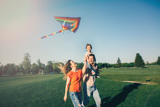Happy family play with kite .