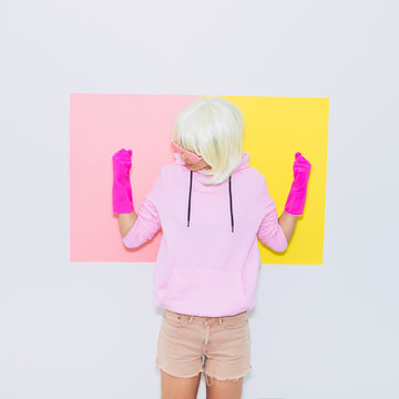 Doll Blonde Girl Model in Fashion sunglasses, gloves,  hoodie and shorts. Club Party Fun. Mood and vibes. Minimal unicorn style. Pink and yellow neon colors