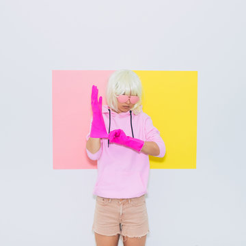 Doll Blonde Girl Model in Fashion accessory sunglasses, gloves,  hoodie and shorts. Mood and vibes. Minimal unicorn style. Pink and yellow neon colors