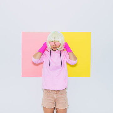 Doll Blonde Girl Model in Fashion accessory sunglasses, gloves,  hoodie and shorts. Club DJ Party Fun. Mood and vibes. Minimal unicorn style. Pink and yellow neon colors