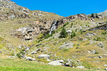 Fototapeta na wymiar Waterfall near Ceresole reale in the Gran Paradiso National Park in Italy