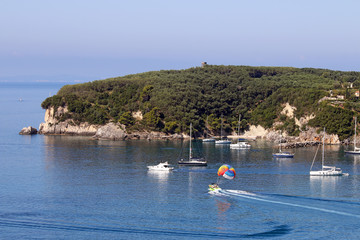 Fototapeta na wymiar sailboats and parasailing Valtos beach Parga Greece summer season