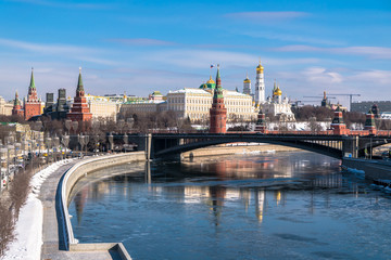 The most recognizable Moscow panoramic view. Bolshoy Kamenny Bridge over the Moscow river. Ancient Kremlin fortress and white stone cathedrals, crowned with golden domes.