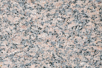 Natural pattern of polished gray-beige granite facing plate. Luxury interior decoration is an...