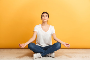 Portrait of a pretty young woman meditating