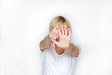 Woman with her hand extended signaling to stop (only her hand is in focus)