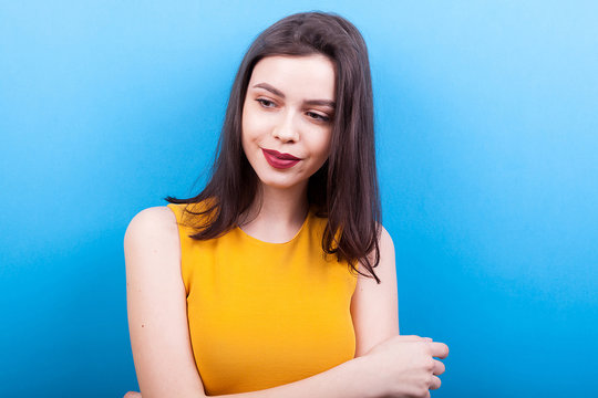 Gorgeous Smiling Woman In Yellow Shirt On Blue Background