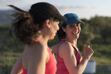  Friends woman talking and smiling outdoors run training in spring day