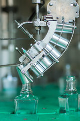 Bottles with a drink closed with a screw cap. Factory for the production of alcoholic beverages