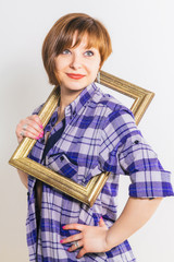 Young thin sexy Woman peers out from the photo frame wearing blue checkered cotton shirt, over...
