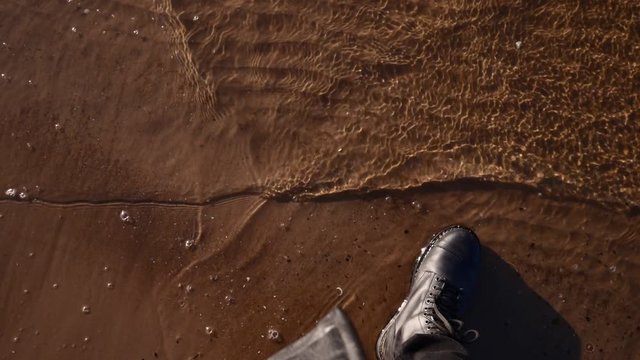 Boots in sea water slow motion