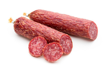 Salami smoked sausage, basil leaves and peppercorns isolated on white background.
