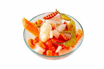 Assorted pickles vegetables carrot, chilli, cauliflower in glass bowl. Top view. Isolated. Copy space.