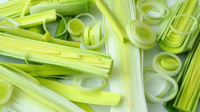 Green stems of cutted leeks isolated on white background 
