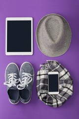 Fototapeta na wymiar Woman's flat lay gray clothes tablet and mobile phone mockup