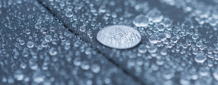 Closeup detailed view of raindrops on a fabric, a background.