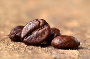 Macro of coffee beans on a wooden table