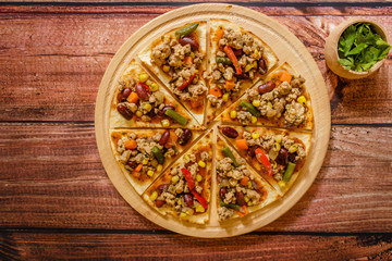 Mexican pork tacos with vegetables and salsa served on wooden plate  on wooden background