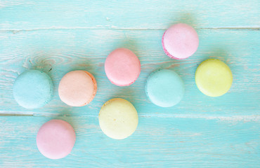 Cookies macarons on wooden turquoise background.Sweet dessert.