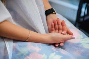 Obraz premium hands girls of the bride with a French manicure wedding day closeup