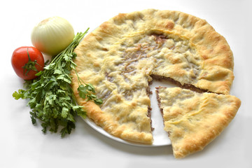 Ossetian pie with stuffing. Homemade pie on a white background