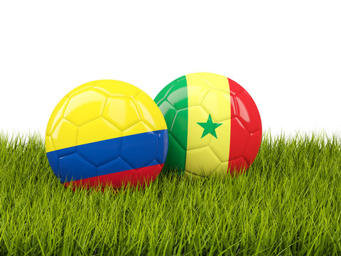 Colombia vs Senegal. Soccer concept. Footballs with flags on green grass