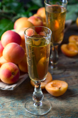 Juicy fresh apricots and glass of sweet liquor.