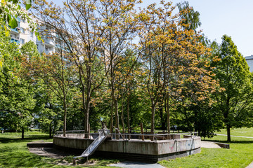 children's playground in park between residential buildings in Berlin Marzahn, Germany
