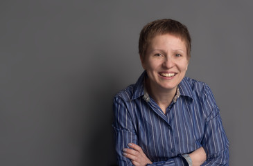 Happy smiling middle-aged woman in blue shirt