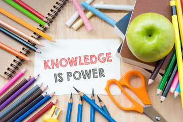 Knowledge is power text on sketching notebook with education accessories.