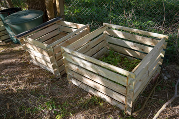 Compost bin as simple wooden silos in the garden