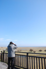 Bird watcher in a tower by a great wetland