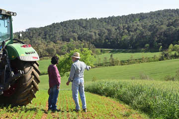couple of farmers looking at a field